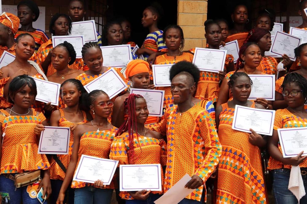 Graduates of a LIPACE skills and livelihoods training holding their certificates